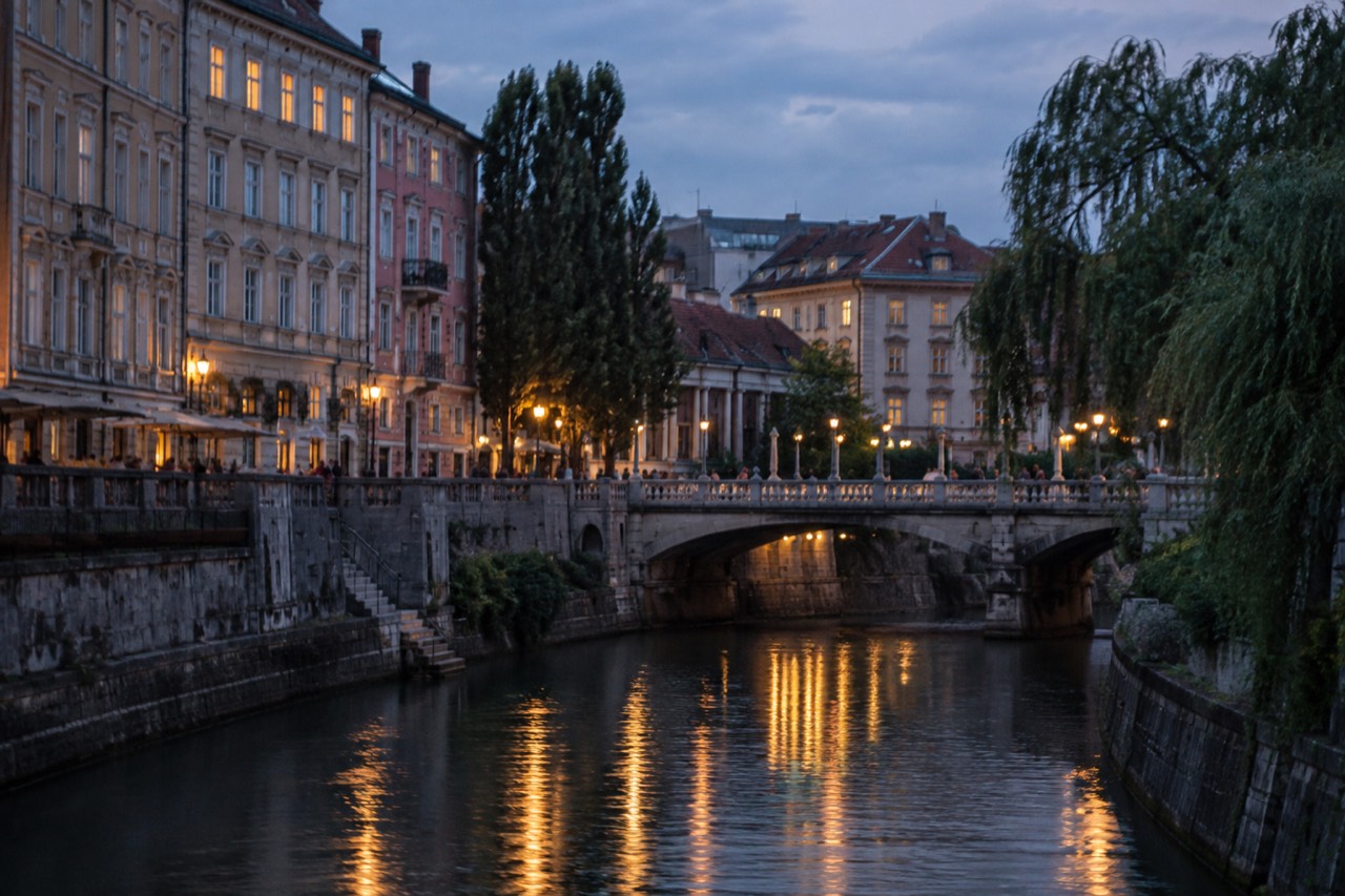 Historic building facades along the Ljubljanica river in central Ljubljana at dusk