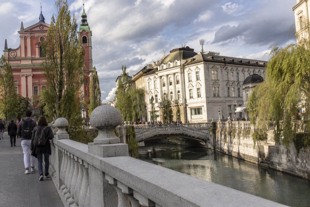 Pastel-coloured baroque buildings beside the Ljubljanica river in the pedestrianised centre of Ljubljana