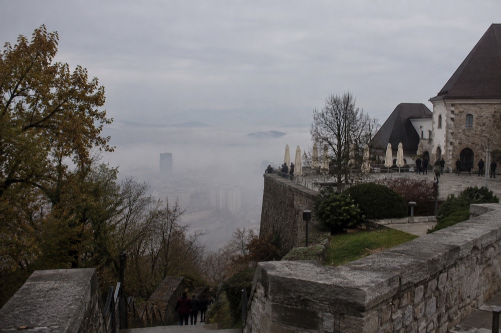 Morning fog filling the Ljubljana basin with the castle hill rising above the mist