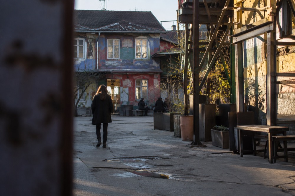 paint-covered walls and welded metal sculpture covering the walls of Metelkova's former barracks