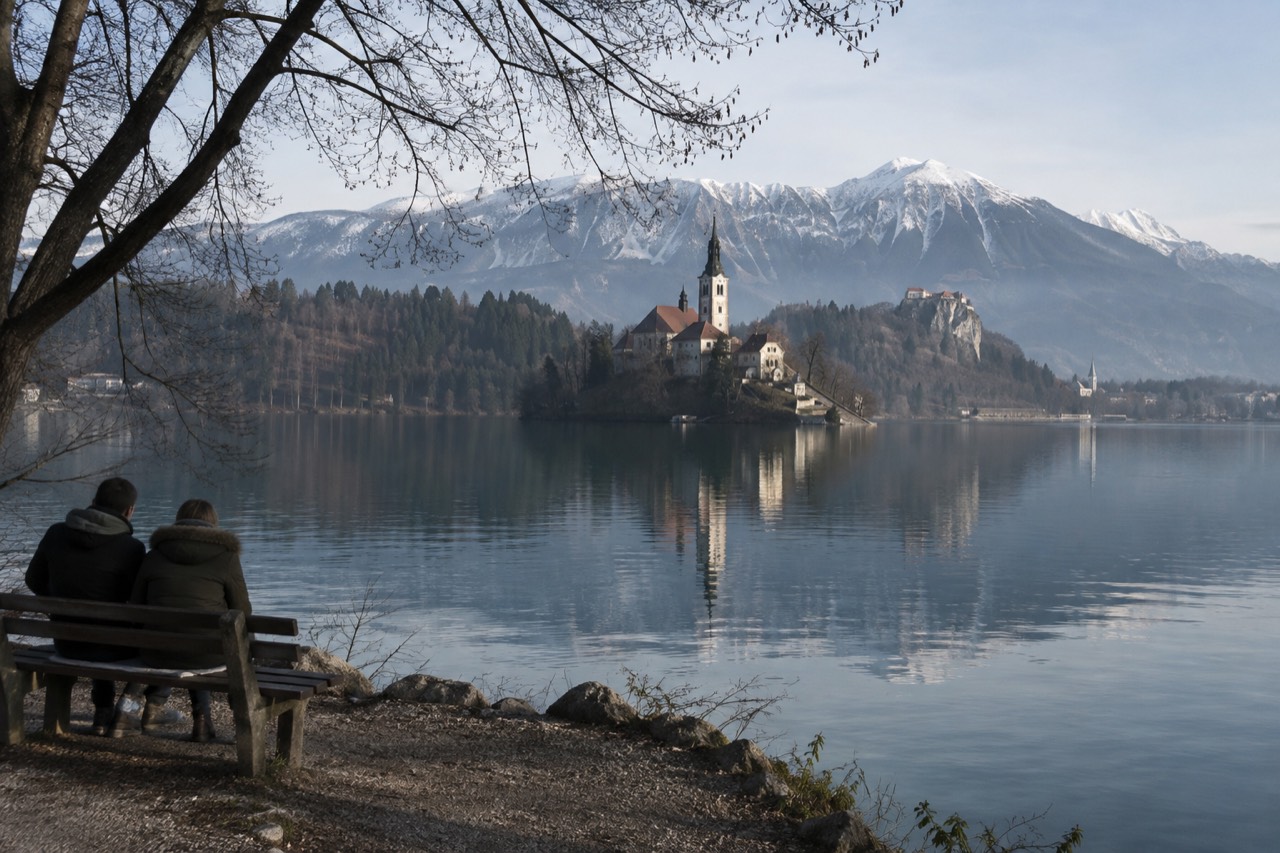 Lake Bled with the island church and the Julian Alps behind calm water