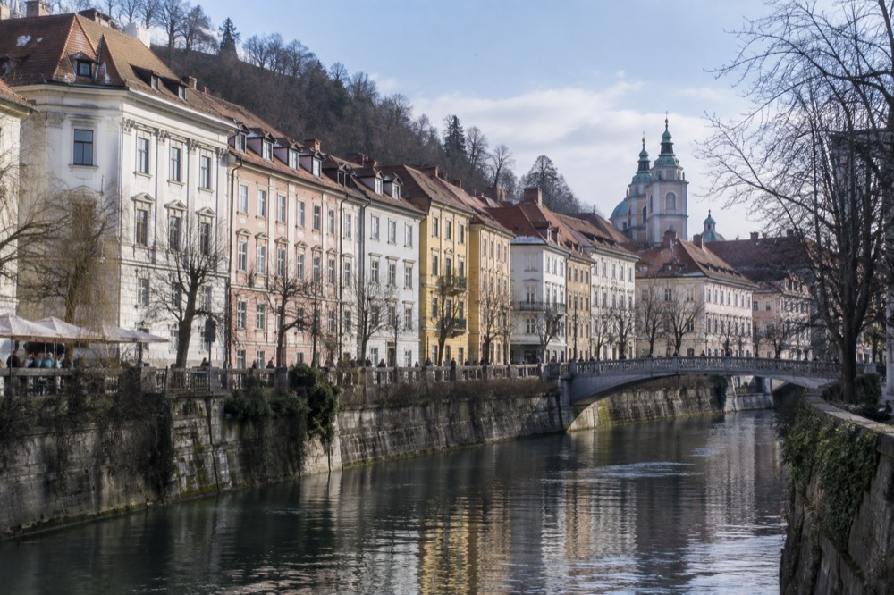 Ljubljana old town rooftops seen across the Ljubljanica river on a bright morning