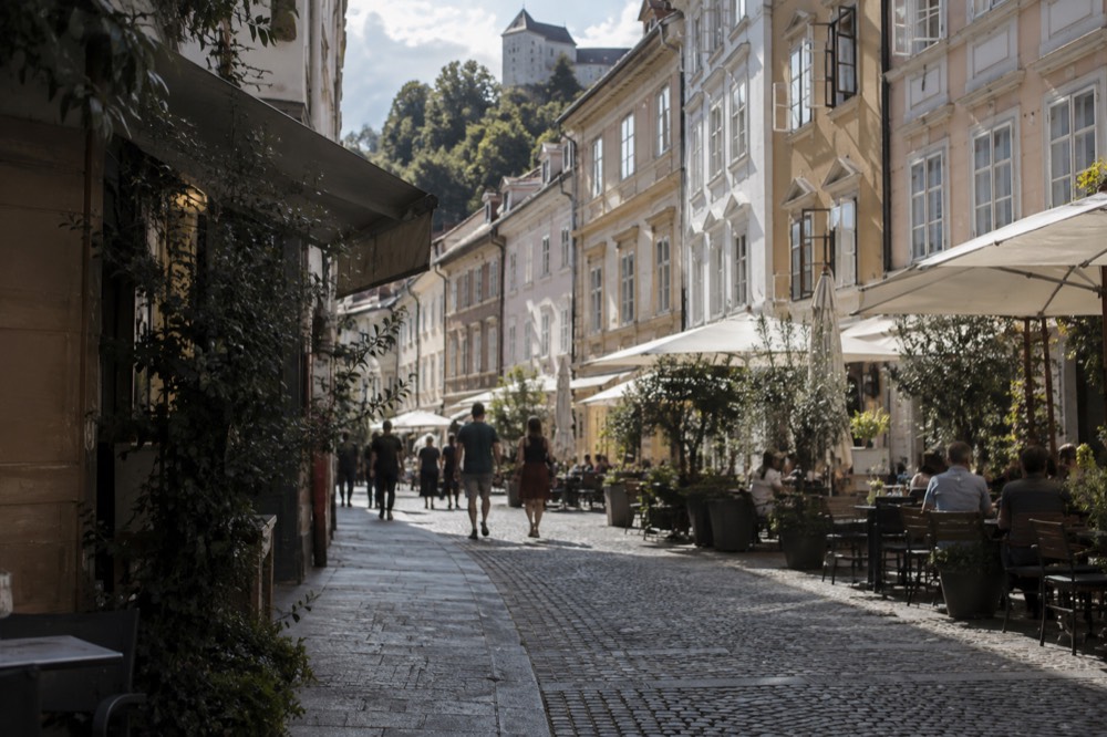 A quiet street of café terraces in the pedestrianised centre of Ljubljana