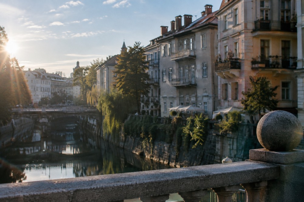 Pastel buildings along the Ljubljanica river in central Ljubljana on a clear morning
