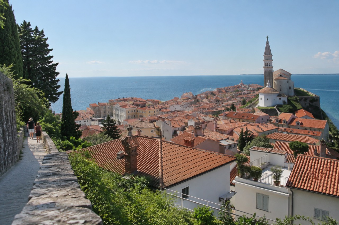 Terracotta rooftops and a church tower above a small Slovenian Piran