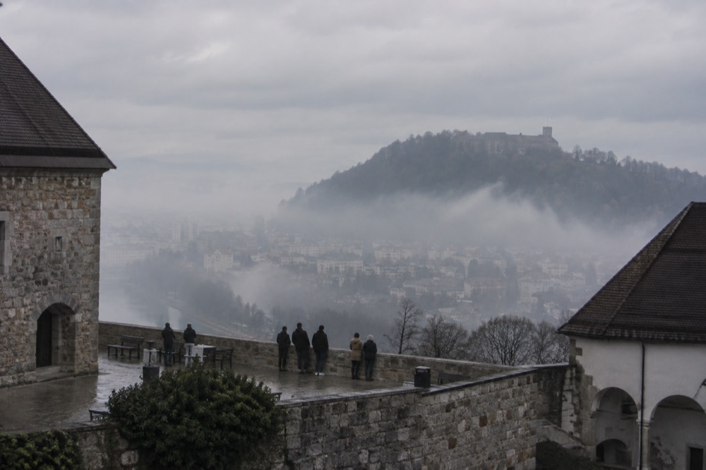 Fog over the Ljubljanica river with the Ljubljana castle hill faintly visible