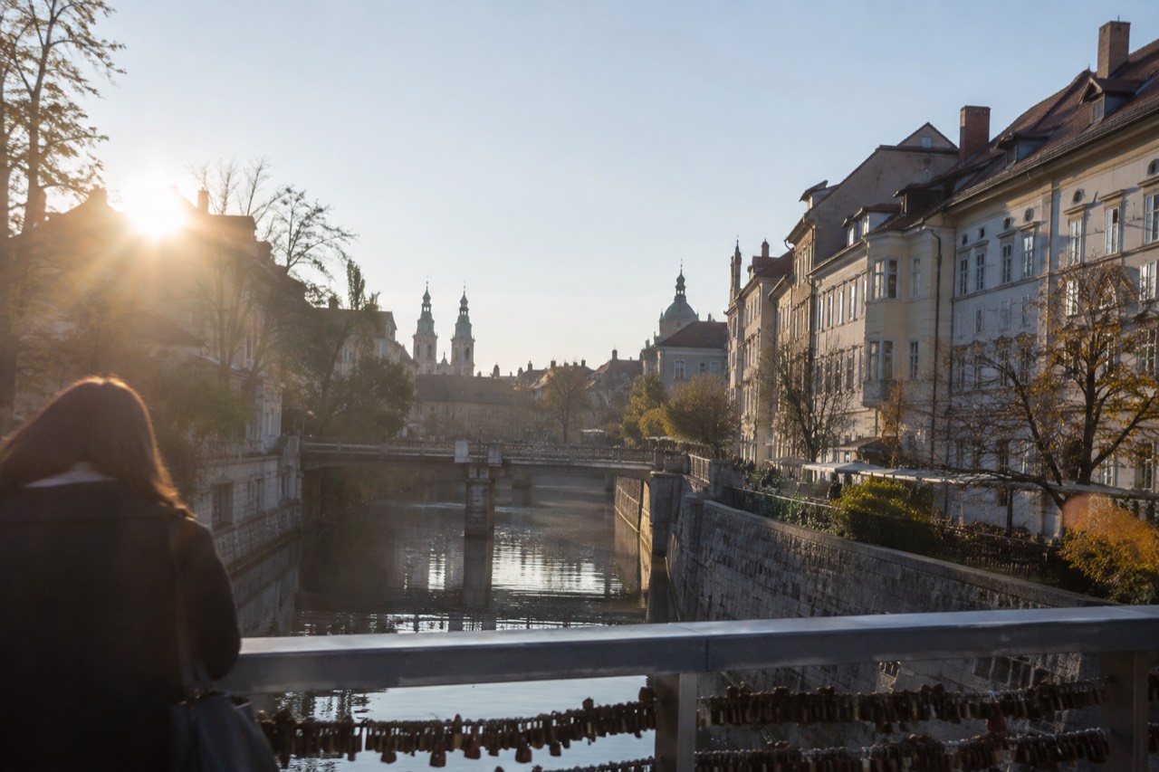 The Ljubljanica river and the old city centre of Ljubljana seen from a bridge on a clear morning