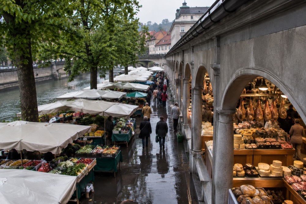 Market stalls with bread, cheese and cured ham in the covered Central Market hall in Ljubljana