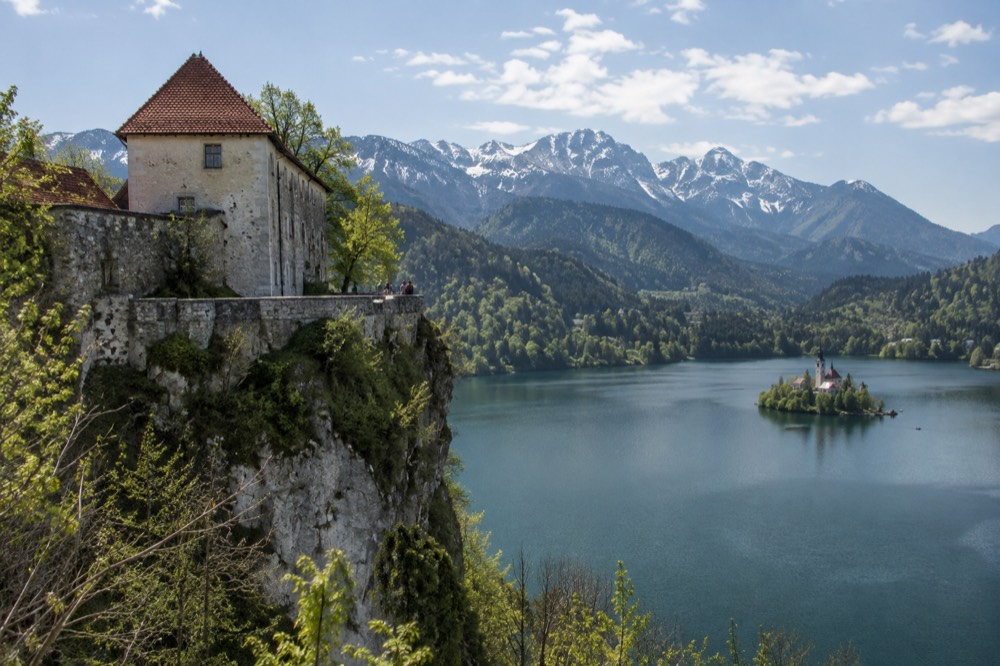 Stone walls of Bled Castle above the lake with the island in the distance
