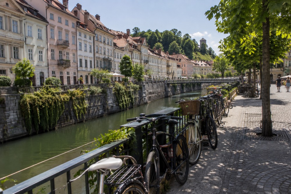 Row of bicycles parked beside a riverside path in central Ljubljana