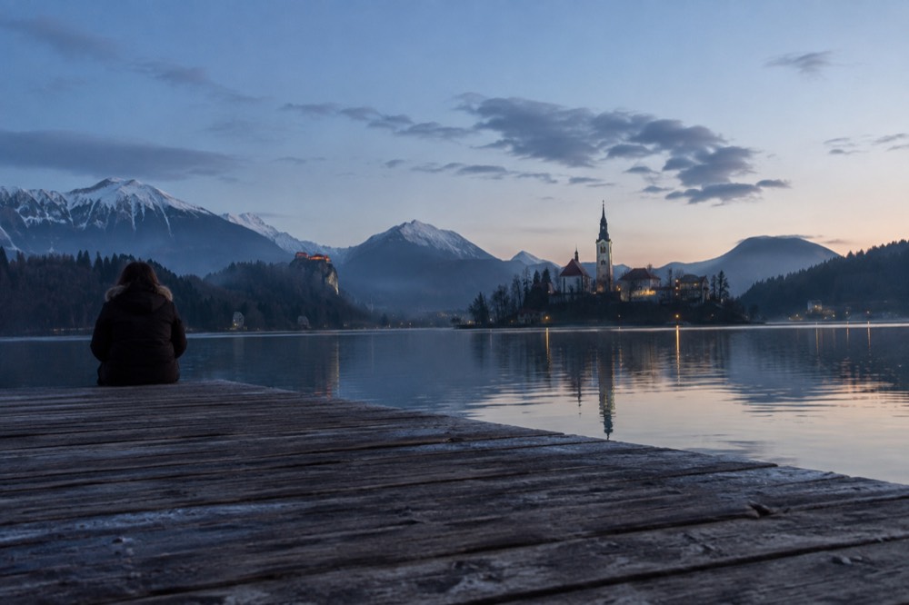 Lake Bled with the island church and wooded shore at first light