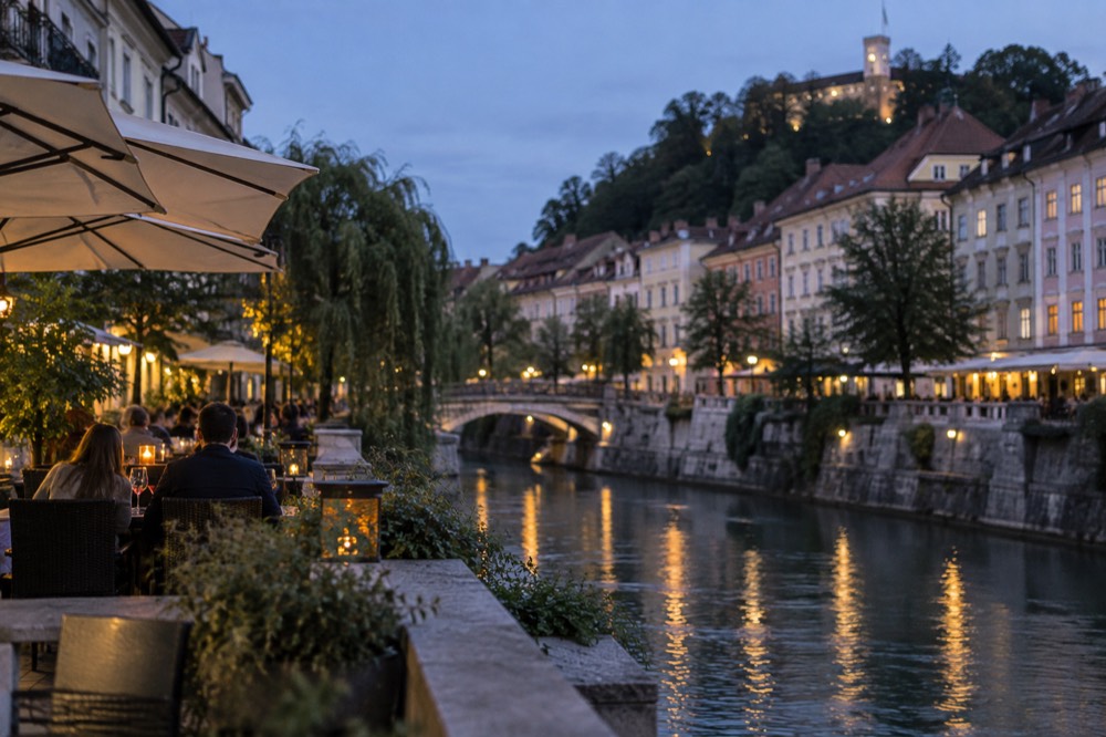 Riverside restaurant terraces with chairs facing the water at dusk