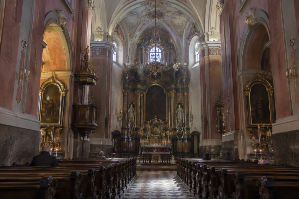 The dimly lit interior of the Franciscan Church with its ornate high altar