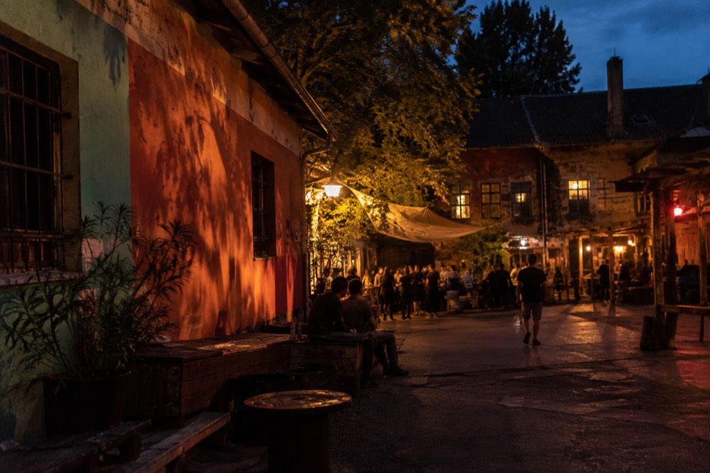 Long evening shadows across a painted courtyard wall
