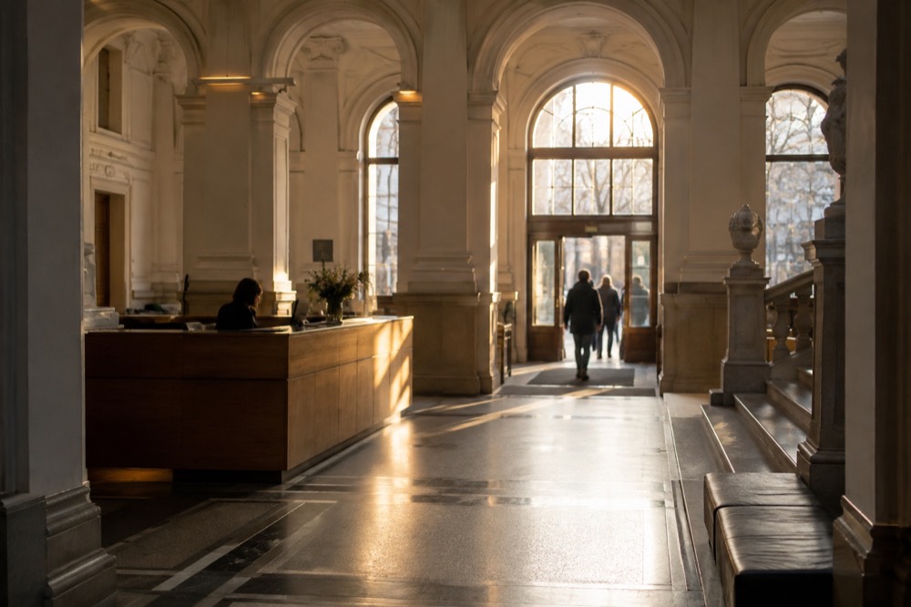 Visitor information desk in a museum lobby with ticket counter and signage