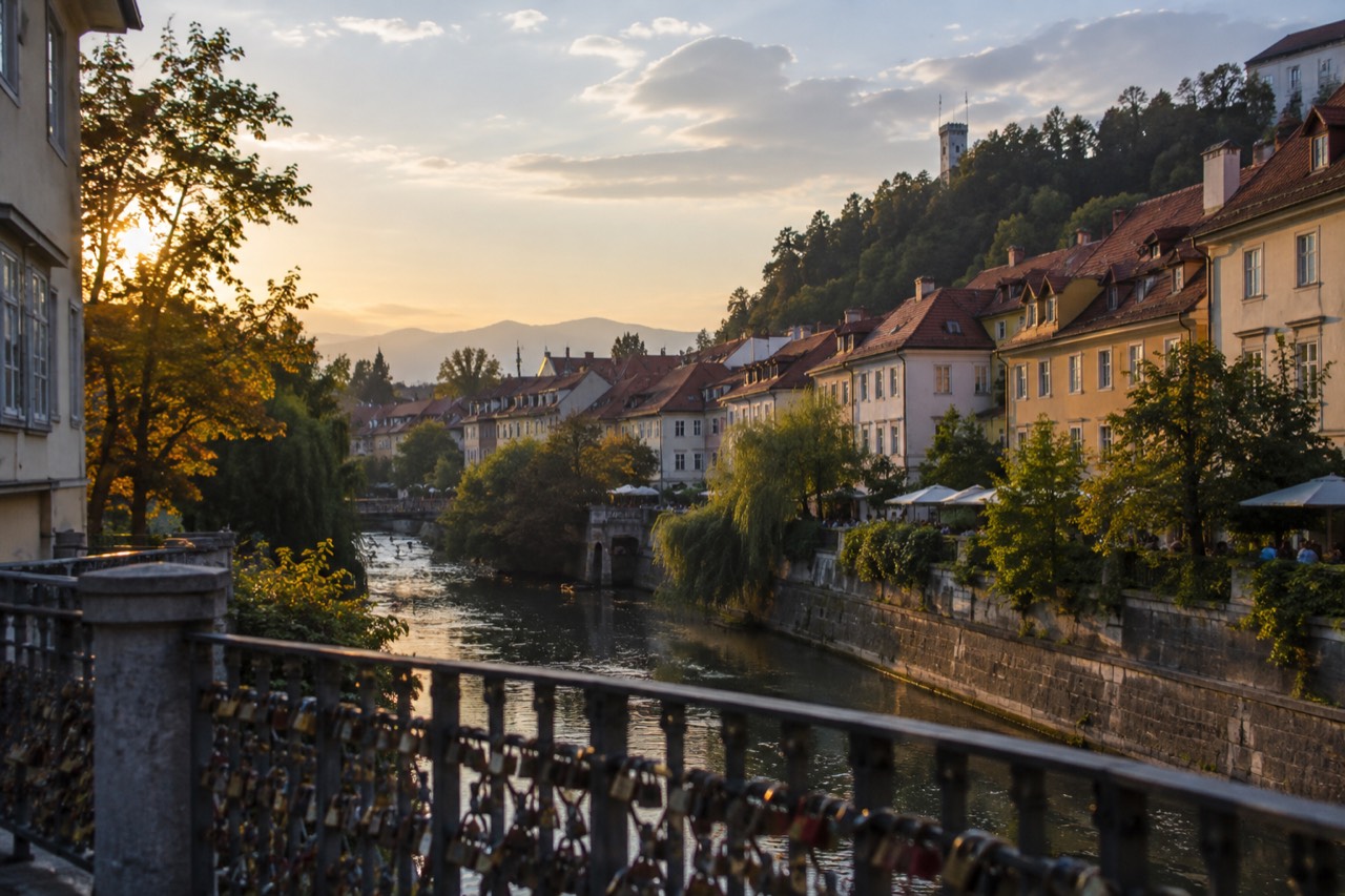 View over Ljubljana's old rooftops and the Ljubljanica river towards the hills beyond the city