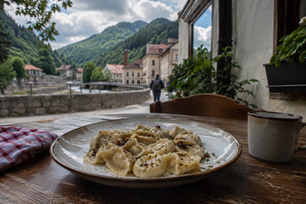 a plate of small hand-pinched dumplings on a wooden tavern table