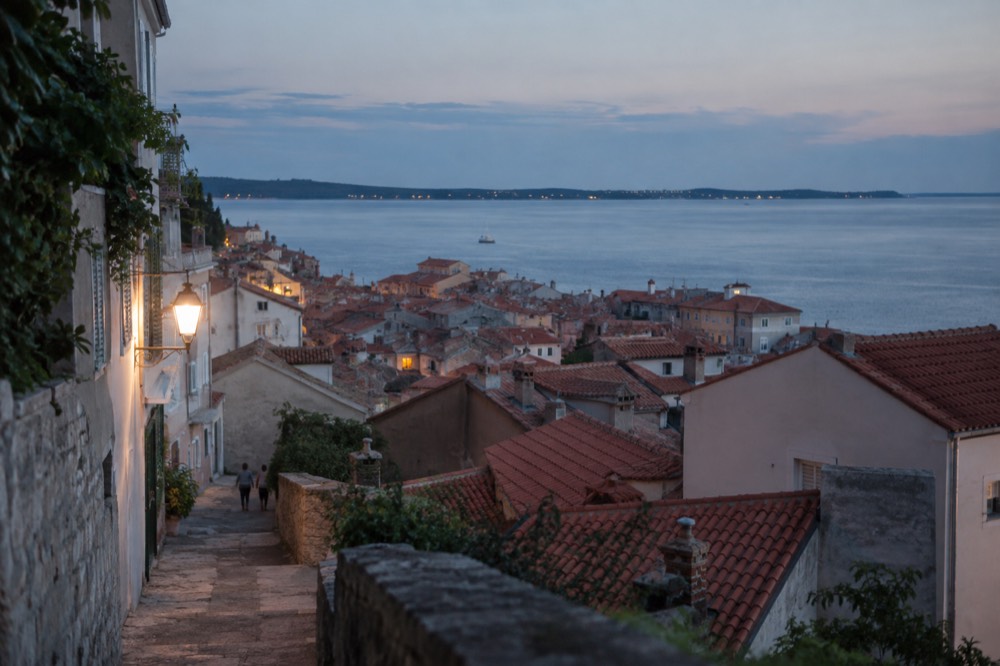 Terracotta rooftops of Piran old town above the Adriatic sea on a clear morning