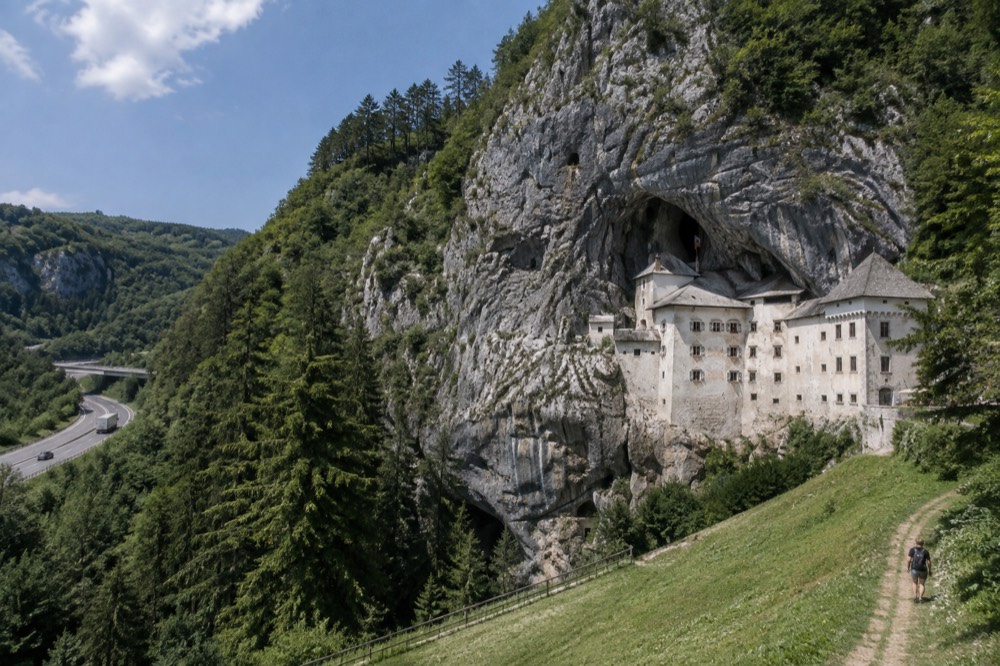 A motorway cutting through forested karst hills in western Slovenia