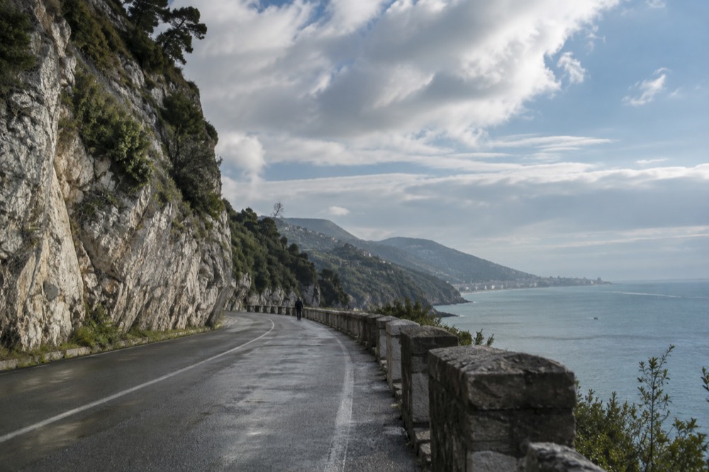 Limestone karst landscape with a road running towards distant hills