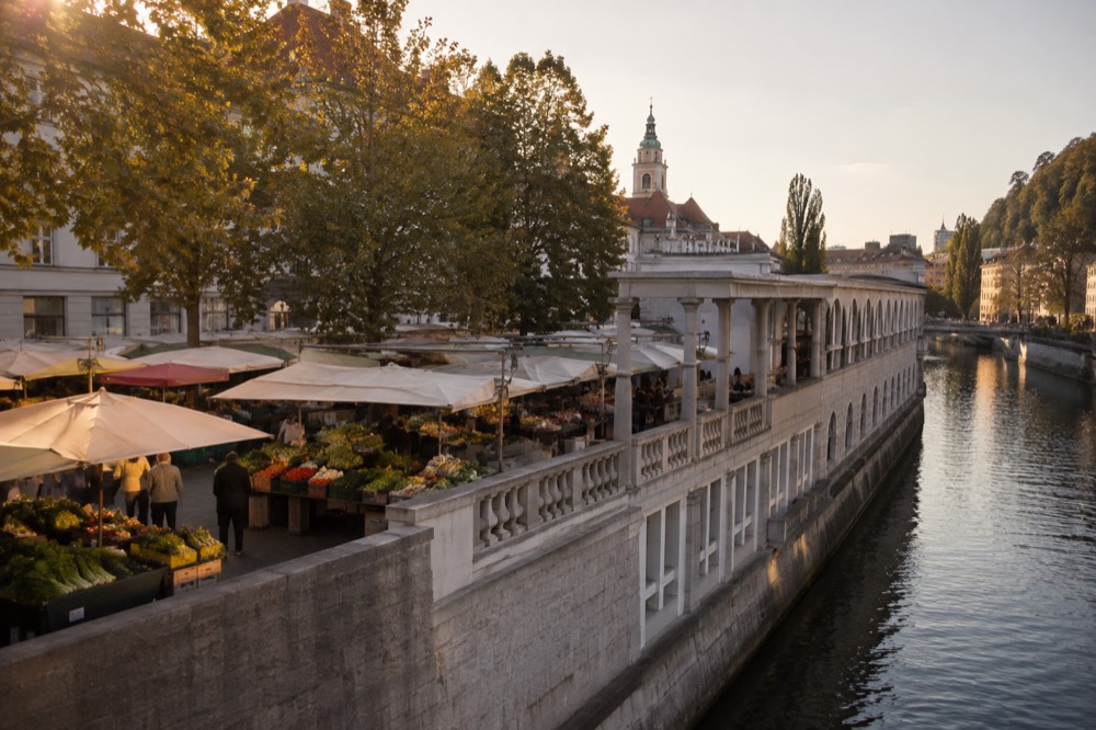 The covered market halls of the Ljubljana Central Market beside the river
