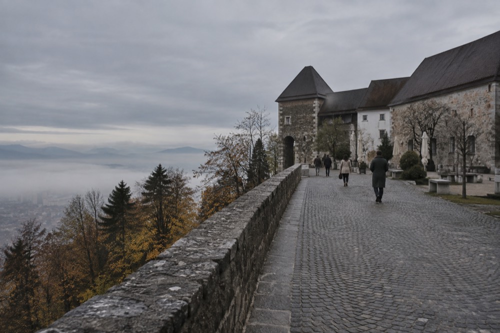 Morning fog filling the Ljubljana basin with the castle hill rising above the cloud layer