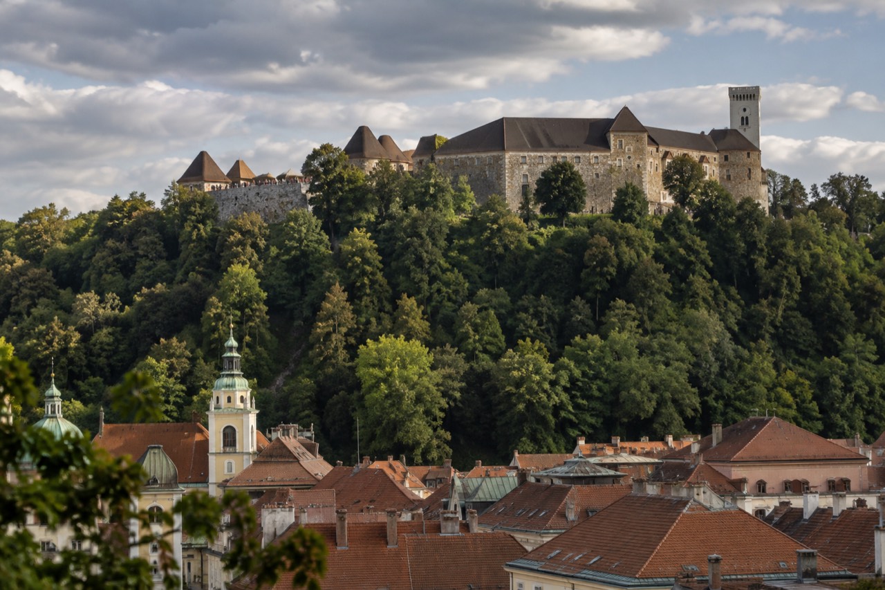 View over the tiled roofs of Ljubljana old town with the castle hill rising behind