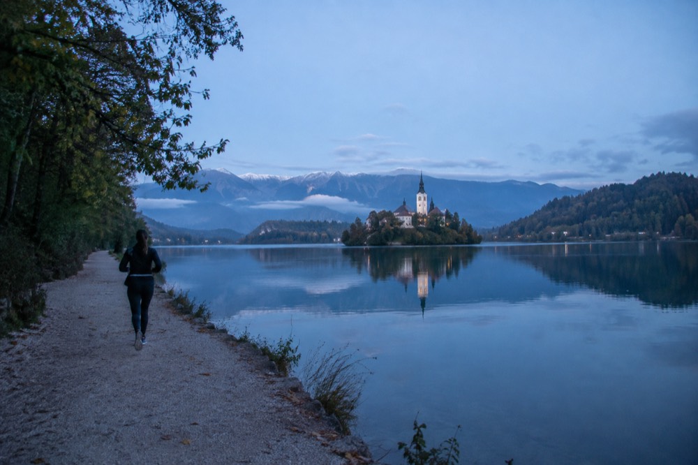 Lake Bled on a clear morning, with the island church and wooded hills reflected in still water