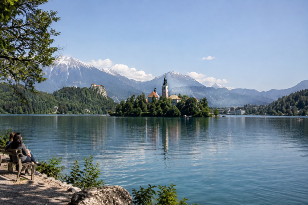 Lake Bled with its island church and wooded shore under a clear sky