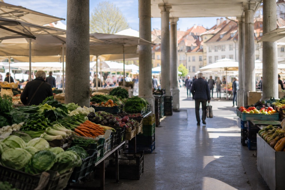 A covered market hall with fresh produce stalls in Ljubljana