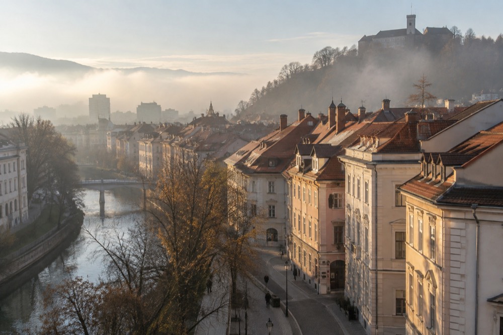 Sunlit hills rising above a foggy Ljubljana basin in cold morning light