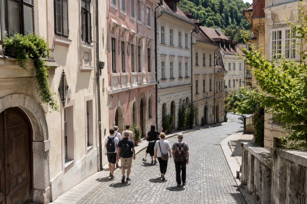 Small group of walkers with a guide on a cobbled old town street