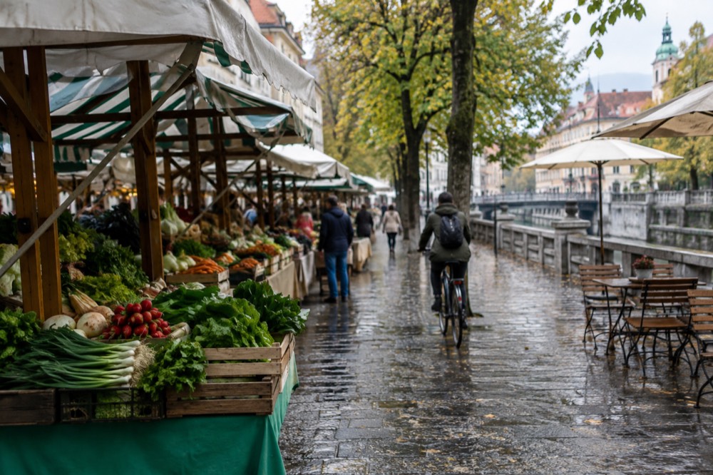 Pedestrian riverside street with café tables and cyclists in the old centre
