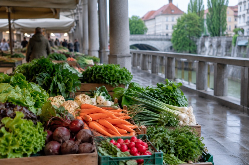 A produce stall under the riverside colonnade of Ljubljana's Central Market