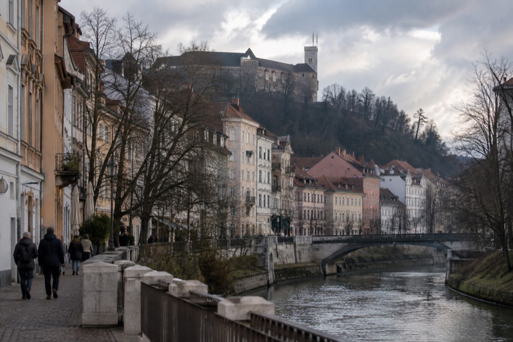 The castle tower and walls above the old town with low winter cloud behind the hill