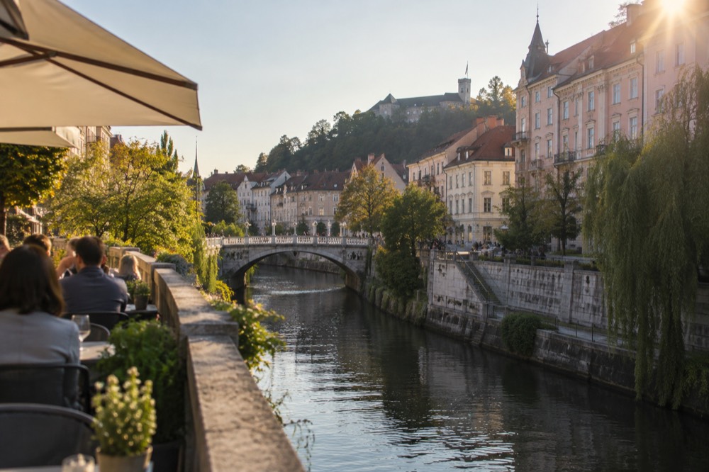 The Ljubljanica river and the old town bridges seen from a riverside terrace