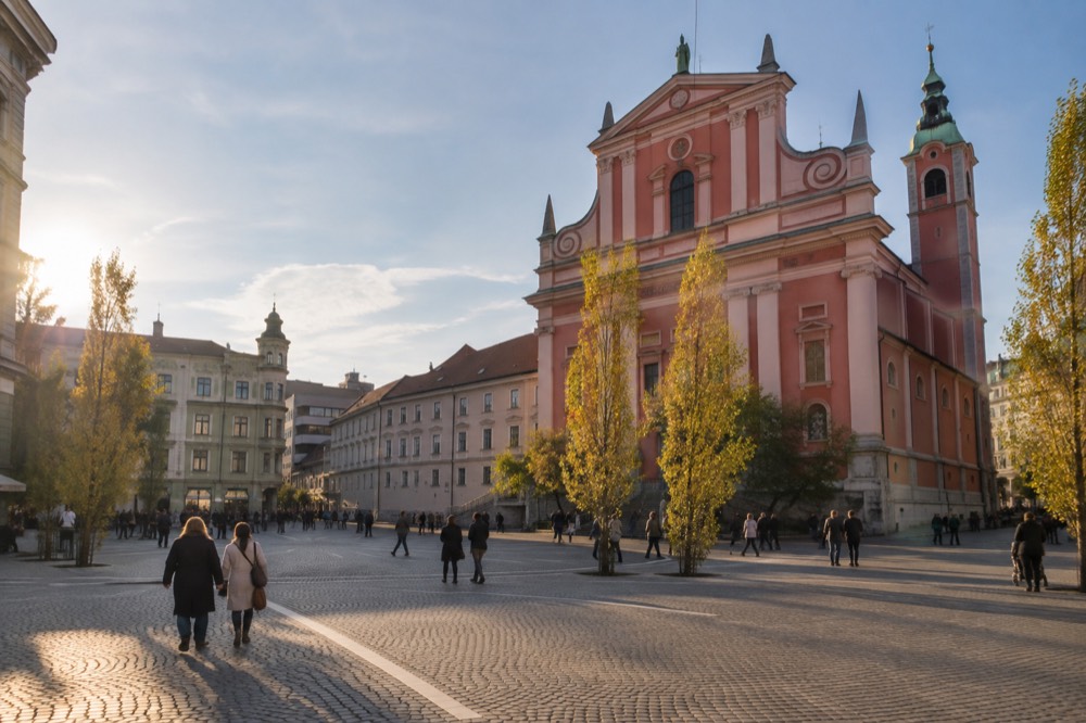 The Franciscan church facade on Prešeren Square in late afternoon light