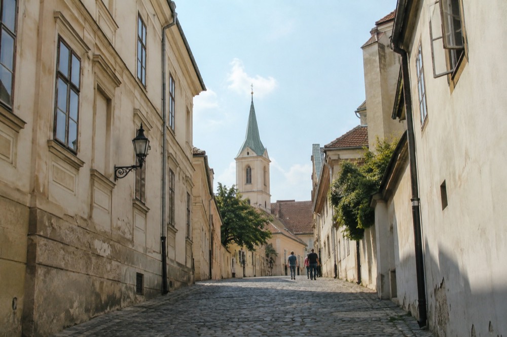 Cobblestone street with historic buildings in an old European upper town