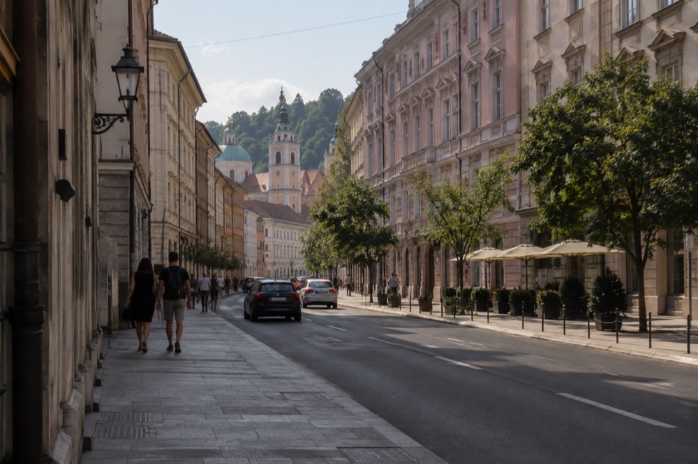 Miklošičeva cesta leading south from the station toward the old town skyline and church towers