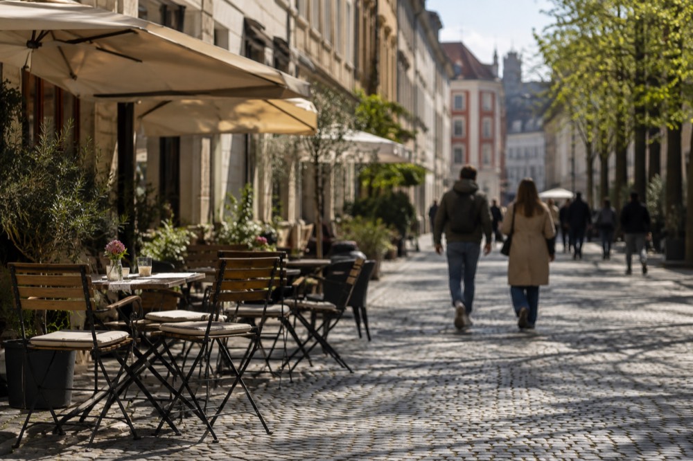 A car-free street in the pedestrianised centre of Ljubljana with cafe tables along the buildings