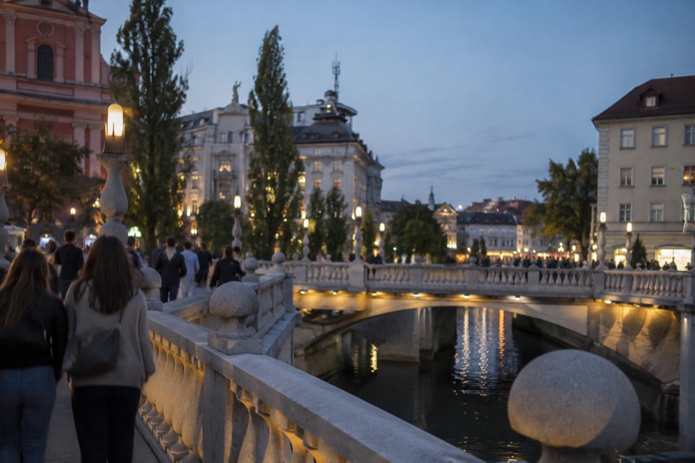Evening light on the Ljubljanica river with the triple bridges and old town facades