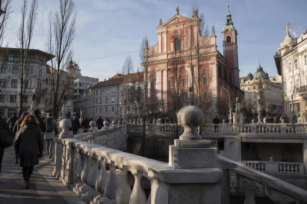 The Triple Bridge crossing the Ljubljanica with the Franciscan Church tower behind