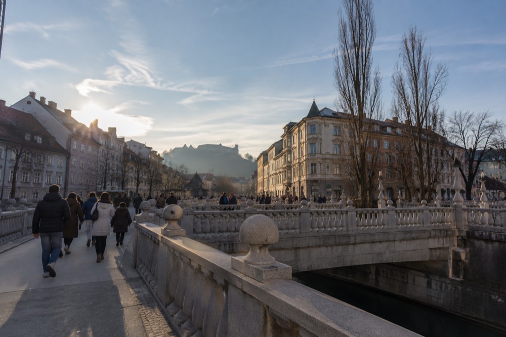 The Triple Bridge and riverside buildings of Ljubljana's Old Town in late afternoon light