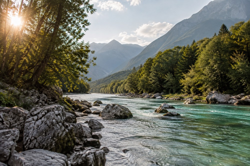 The emerald Soča river winding through a green alpine valley