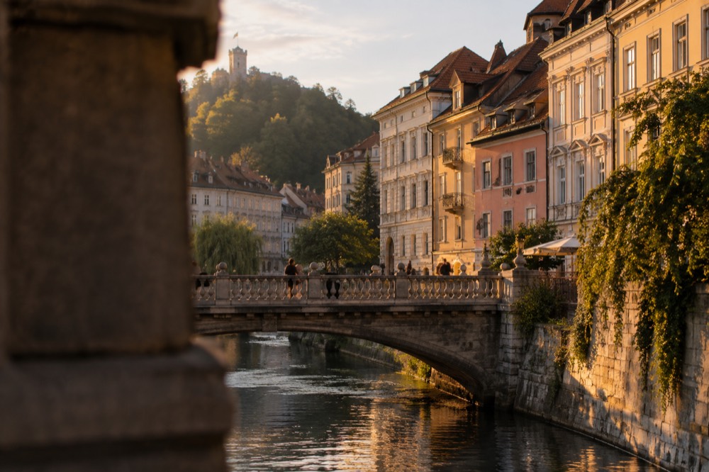 Stone bridge with balustrades spanning a river in Ljubljana