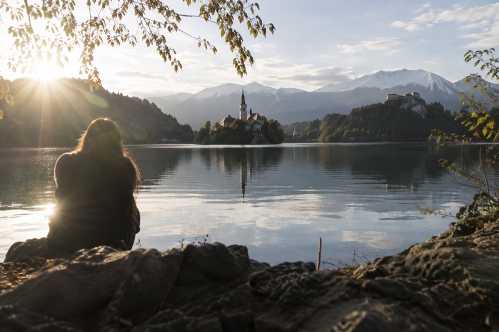 Lake Bled with the island church and the castle cliff above still water
