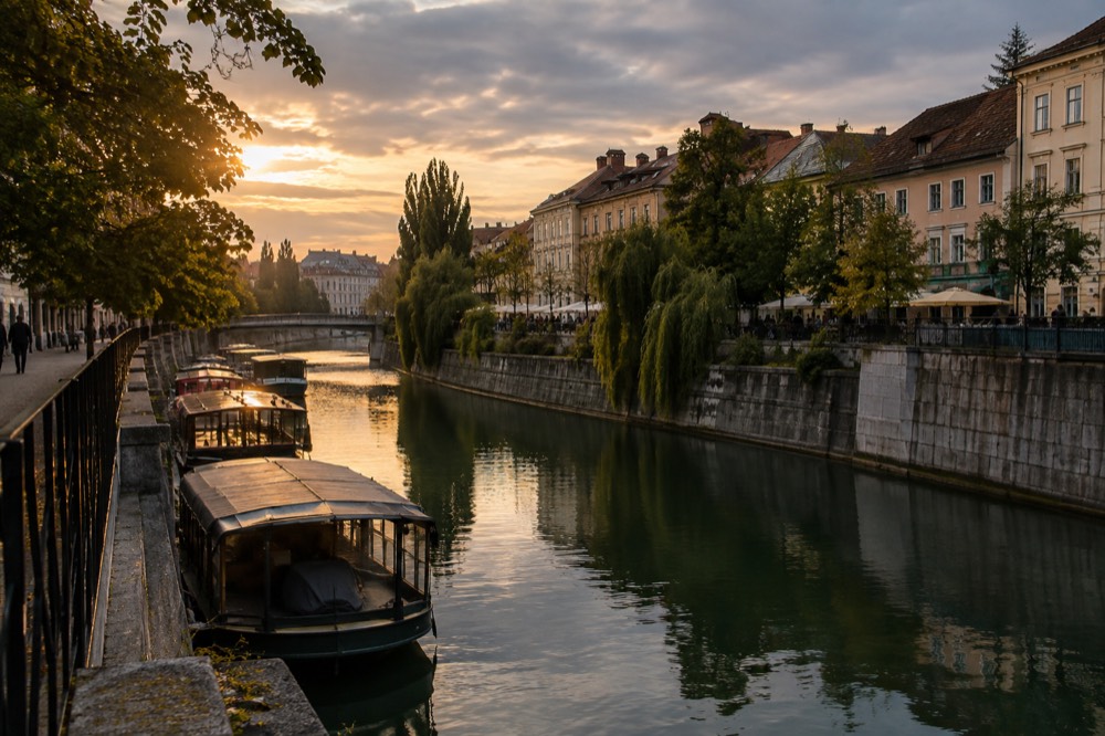 The Ljubljanica river embankment with moored boats under low cloud