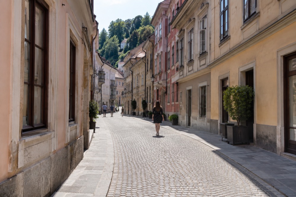 A quiet cobblestone street in the old town with pastel building facades